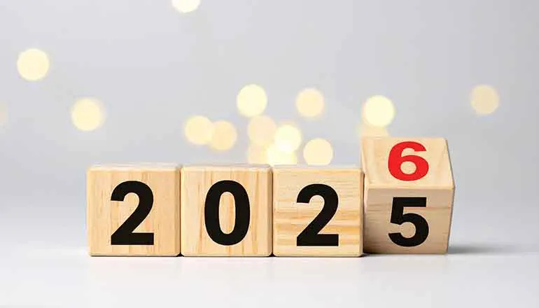 4 houten blokken met getallen die verschuift van 2025 naar 2026 