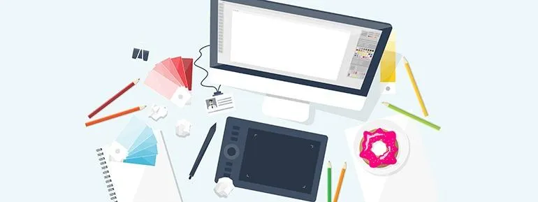 Een afbeelding van een monitor met een ipad en grafische spullen eromheen 